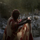 A woman working as a grave crusher adjusts her dress at a site near the Cite International des Affaires in N’Djamena, on April 12, 2021.
